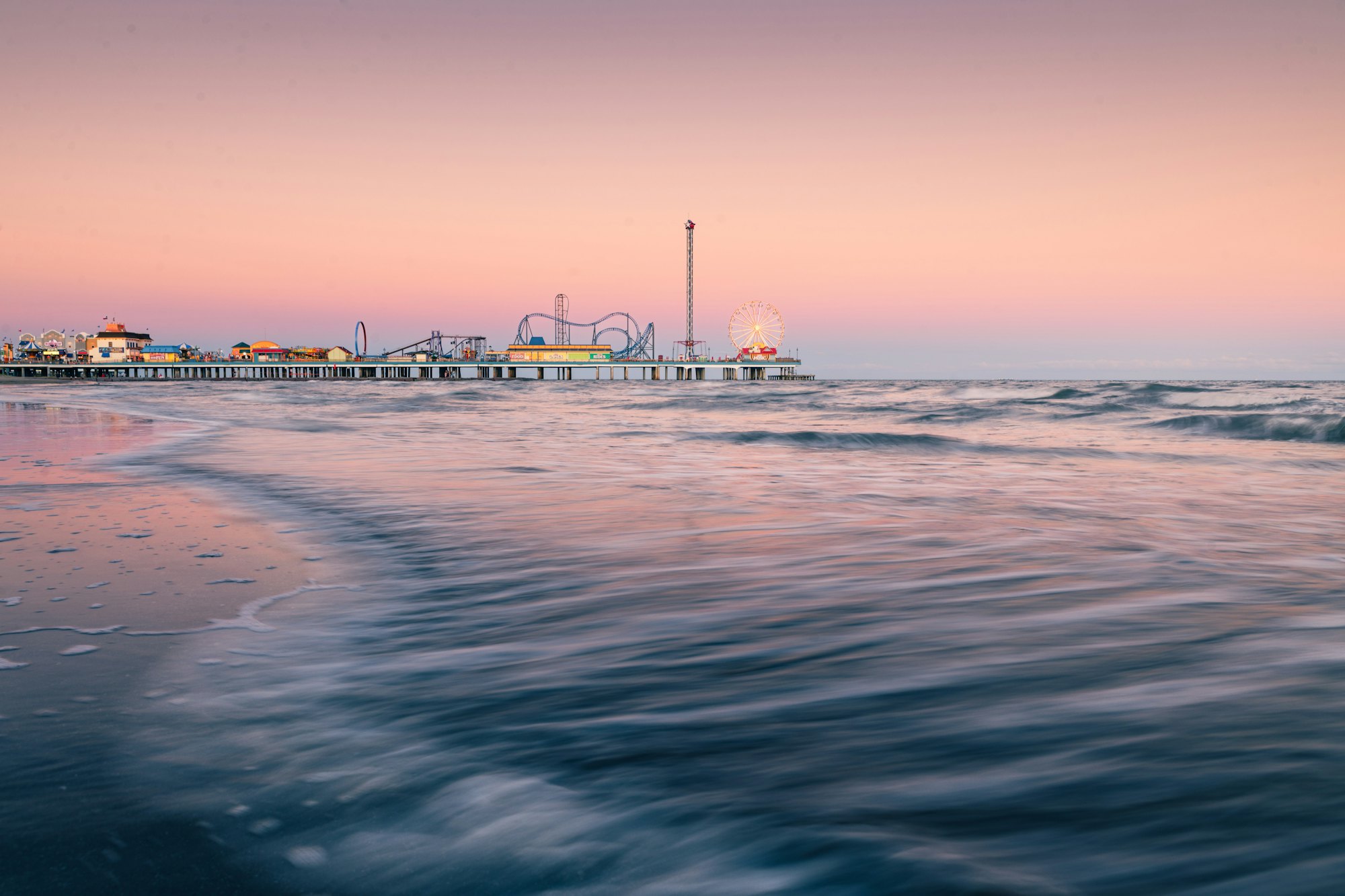 Galveston Pleasure Pier at sunset over the Gulf of Mexico